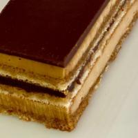 Opéra · Opéra is a French cake. It is made with layers of almond sponge cake soaked in coffee syrup,...