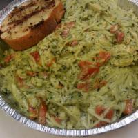 Chicken Pesto Pasta · Roasted chicken breast tossed with linguini in a creamy pesto sauce topped with roasted red ...