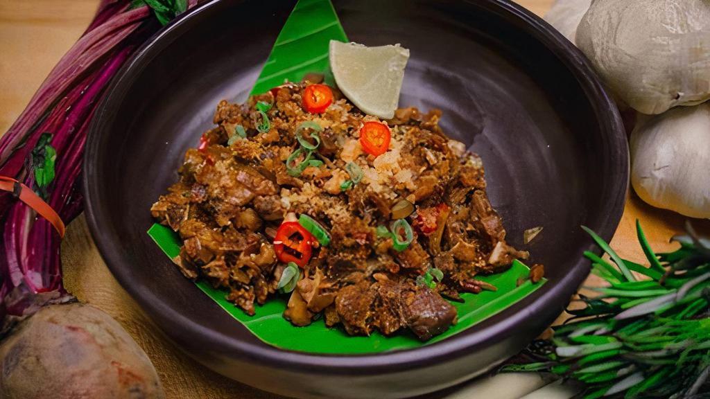 Pork Belly Sisig Appetizer · Sauteed headcheese, onions, bell peppers, and chilies.