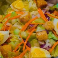 Kj'S Chopped Salad · Romaine, cucumbers, eggs, tomatoes, carrots, red onions, croutons, and calamansi mustard vin...