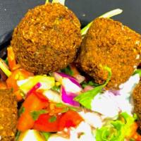 Falafel Over Rice And Soda · Served with crispy falafel, rice, lettuce, and tomatoes along with your favorite toppings an...