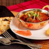 Lamb Kadai · Tender lamb cubes cooked in a wok with tomatoes, onions, bell peppers, ginger and garlic.