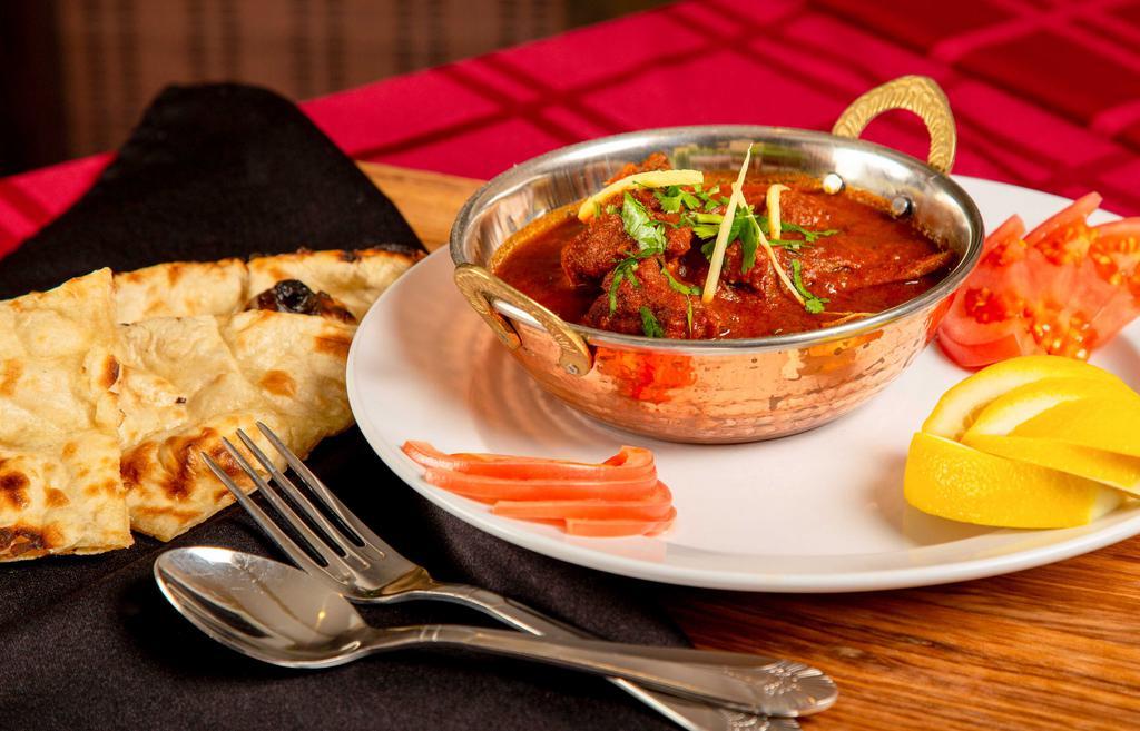Lamb Kadai · Tender lamb cubes cooked in a wok with tomatoes, onions, bell peppers, ginger and garlic.