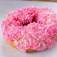 Pink Sprinkle Cake (Vanilla) · Plain cake donut covered with vanilla frosting and topped with pink sprinkles.