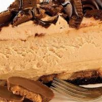 Reese'S Pb Cheesecake · Peanut butter New-York style cheesecake with a chocolatey fudge bottom; topped with peanut b...