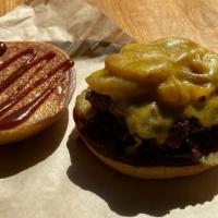 Ranch Hand Burger · Tillamook Cheddar, smoked bacon, caramelized onions, pickles, and BBQ sauce.