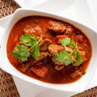 Punjabi Goat Curry · Goat slow cooked with onions, coriander, and cayenne, black cardamom and mace.