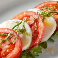Tomato Caprese Salad · Regular. Vine-ripened tomatoes, arugula, fresh mozzarella, basil, balsamic drizzle.