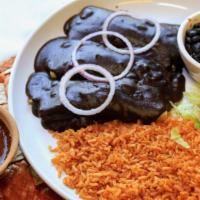 Enchiladas Banderas · A plate with three enchiladas filled with meat, covered with different types salsa.