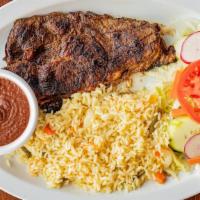 Carne Asada / Grilled Steak · Bistec a la parrilla servido con arroz, frijoles y ensalada. / Grilled steak served with ric...