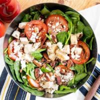 Side Spinach Salad · Fresh baby spinach topped with Roma tomatoes, feta cheese, and Texas pecans. Try adding gril...