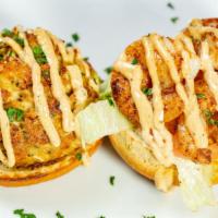 Surf Burger · Our crab cake topped with three large shrimp, drizzled with our house Chesapeake sauce on a ...
