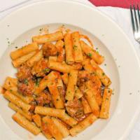 Rigatoni Con Salcicia · Pasta with Italian sausage and tomato sauce.
