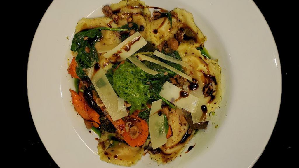 Ravioli  · Stuffed with organic Stahlbush Island Farms (Corvallis, OR) butternut squash, gorgonzola, parmesan, and ricotta cheeses. Tossed with spinach, olives, market vegetables, hazelnuts, EVO, pesto, parmesan, balsamic drizzle, herb-spinach nage & chimichurri sauce