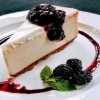 New York Style Cheesecake · Creamy Cheesecake, served with rotating seasonal fruit compote, vanilla whip, & berry sauce