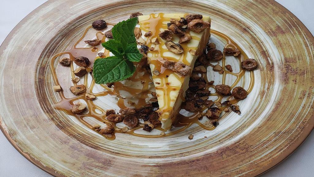 Nw Hazelnut Cheesecake · New York style cheesecake drizzled with caramel sauce and topped with candied Oregon hazelnuts. Served with vanilla whipped cream