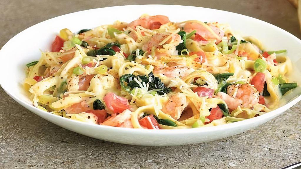 Shrimp Fettuccine Alfredo · Sautéed shrimp, spinach and diced tomatoes, in our Old Bay spiced Alfredo sauce, served over fettuccine, topped with shredded Parmesan cheese and fresh-cut scallions.