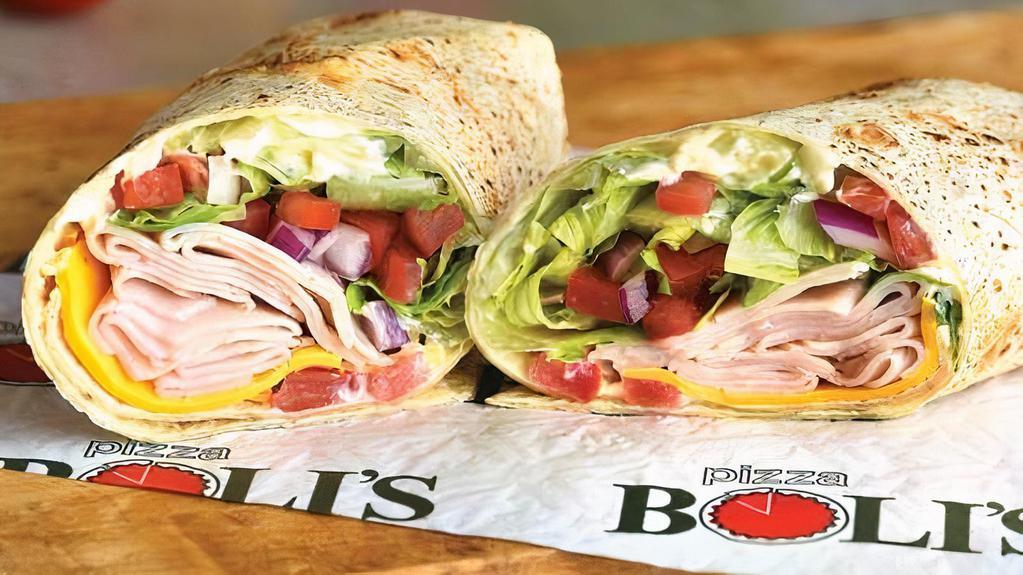 Sliced Turkey Wrap · Smoked oven roasted turkey breast, American cheese, romaine lettuce, tomato, red onions, mayonnaise.