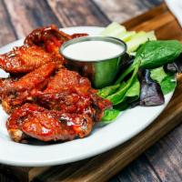 Spicy Chicken Wings · 1 lb. of wings and drumettes tossed in our own house hot sauce. Served with blue cheese dres...