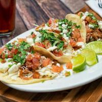 Carnitas Tacos · Chipotle pork, shredded cabbage, feta cheese on white corn tortillas with pico de gallo and ...