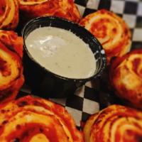 Pizza Rolls · Handmade dough rolled with pepperoni pizza topping served with ranch.