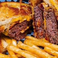 Hoolies Double It Up · 2 Patties, double american cheese and bacon served
between two grilled cheese sandwiches.