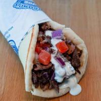 Beef Shawerma Wrap · Beef shawarma slices wrapped in pita bread with tomatoes, onions, garlic sauce and tahini sa...