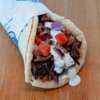 Doner Wrap(Beef) · Slices of beef wrapped in pita bread with tomatoes, red onions, garlic sauce and tzatziki sa...