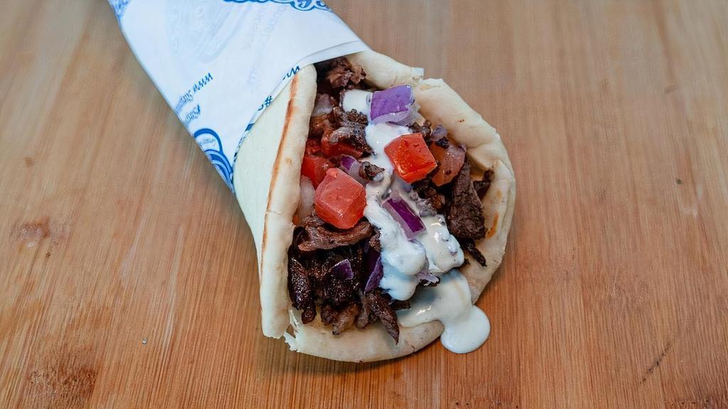 Doner Wrap(Beef) · Slices of beef wrapped in pita bread with tomatoes, red onions, garlic sauce and tzatziki sauce.