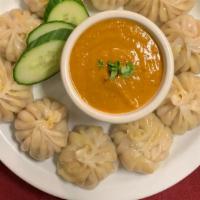Nepali Momo · Steamed dumpling filled with fresh ground chicken, vegetables and spices.