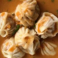 Jhol Momo · Nepali Chicken momo served with our special tomato sauce.