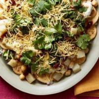 Chat Papri · Homemade wheat chips, diced potatoes and chickpeas smothered with whipped yogurt and tangy t...