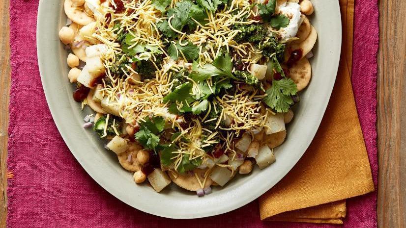 Chat Papri · Homemade wheat chips, diced potatoes and chickpeas smothered with whipped yogurt and tangy tamarind sauce.