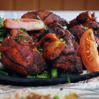 Tandoori Chicken · Chicken marinated in yogurt and freshly ground spices, skewered and grilled in a clay oven.