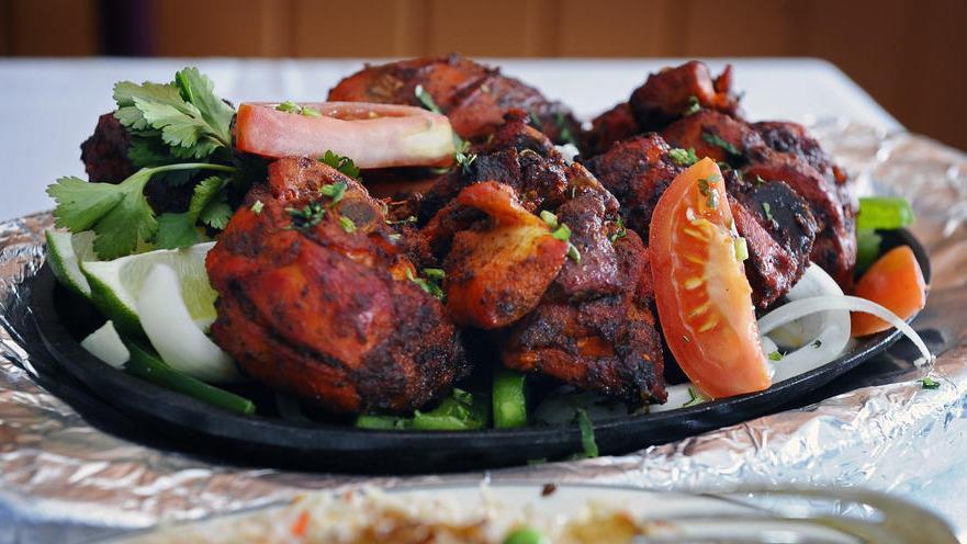 Tandoori Chicken · Chicken marinated in yogurt and freshly ground spices, skewered and grilled in a clay oven.