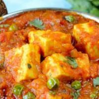 Matar Paneer · Homemade cheese and green peas cooked in a creamy masala sauce.
