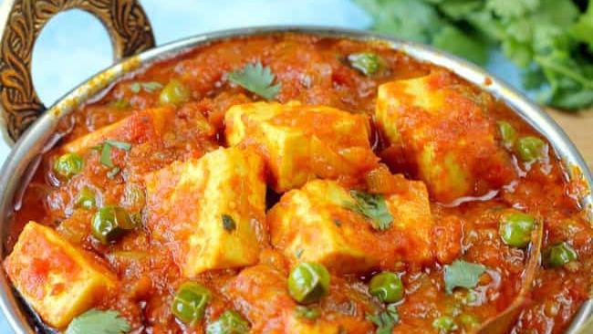 Matar Paneer · Homemade cheese and green peas cooked in a creamy masala sauce.