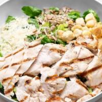 Chicken Caesar Salad · Grilled all-natural chicken, romaine lettuce, Parmesan cheese, sunflower seeds, croutons, an...