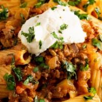 Rigatoni Bolognese · Mild meat sauce with pear tomatoes, roasted peppers, garlic and cream
