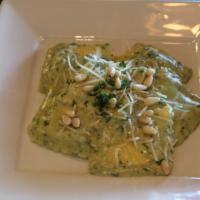 Asiago Cheese Ravioli · Tossed in our pesto cream sauce with pine nuts