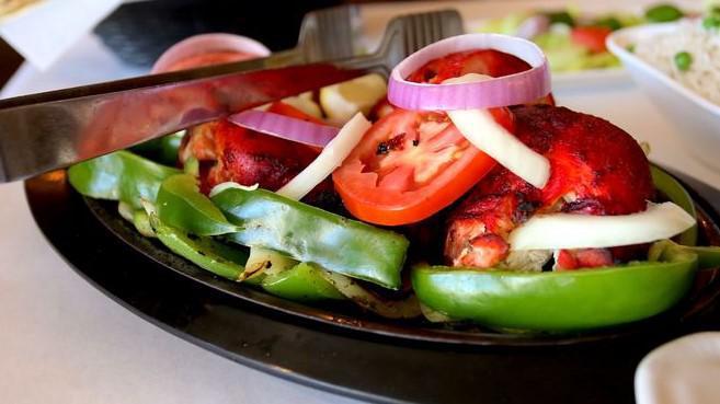 Tandoori · meat marinated in yogurt, spices and roasted in our special tandoor clay oven with bed of bell peppers, onino and lemon.