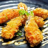 Crab Crab Tempura · Tempura fried crab sticks (imitation) topped with green onions, furikake and drizzled spicy ...