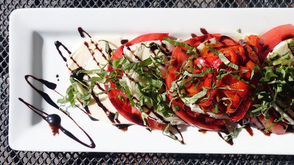 Caprese · Homemade mozzarella sitting atop thickly
sliced beefsteak tomatoes with roasted red peppers
and basil, drizzled with balsamic glaze.