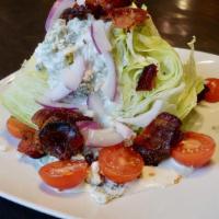 Iceberg Wedge  · Bleu cheese crumbles, cherry tomatoes, red onion,
smoked applewood bacon and bleu cheese dre...