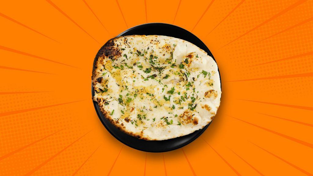 Garlic Naan · A refined flour leavened flatbread, sprinkled with finely chopped garlic and baked in a clay oven till crisp on the outside and soft on the inside.