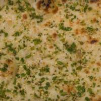 Garlic Naan · Leavened homemade bread baked in a clay oven with garlic, cilantro, and butter.