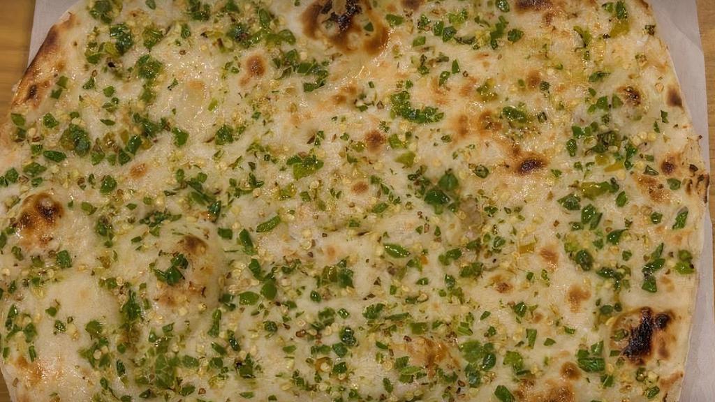 Garlic Naan · Leavened homemade bread baked in a clay oven with garlic, cilantro, and butter.