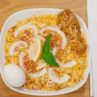 Chicken Biryani · Basmati rice cooked with chicken with bone, Indian herbs and garnished with cilantro and lim...