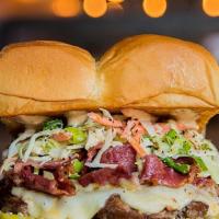 The Mensch Burger · White American cheese, pickles, pastrami, Haus slaw, and 1000 Island on a king's Hawaiian ro...