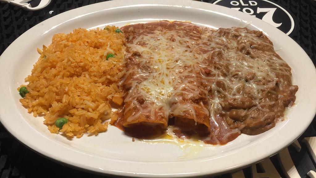 C. Chicken Enchiladas · Two chicken enchiladas with sour cream sauce and jack cheese or green sauce. All plates served with rice and beans.